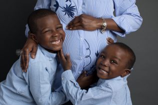 Boys hugging pregnant mom